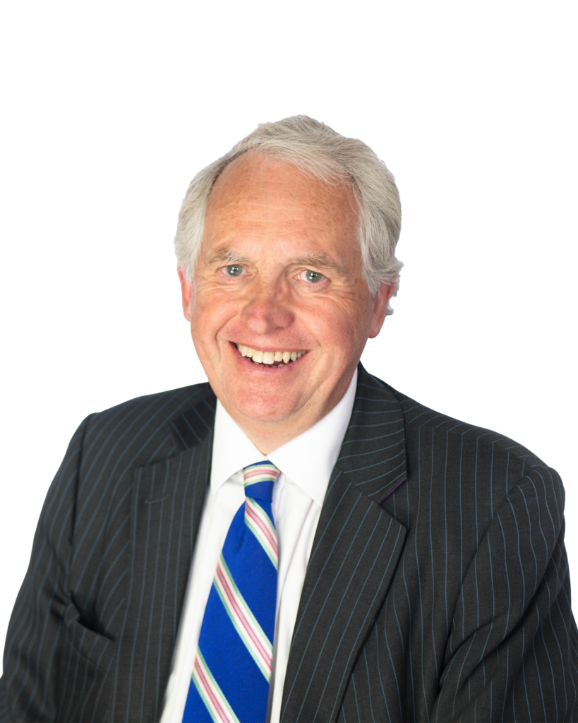 Stuart smiles at the camera wearing a stripy tie. The background is white.